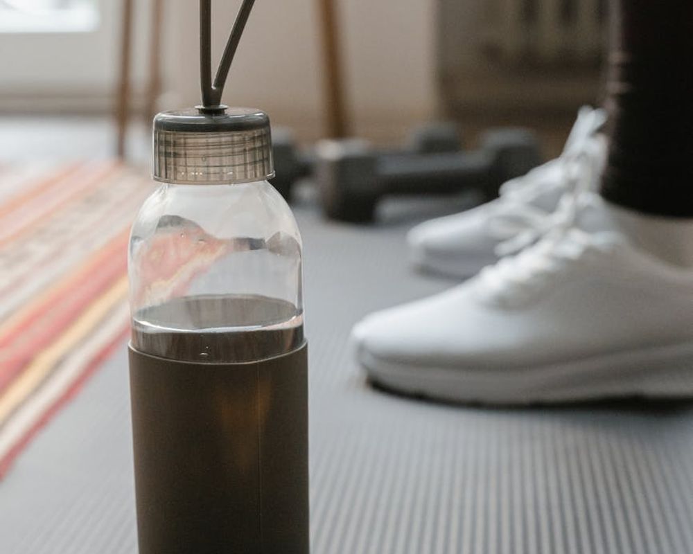 Detailed close-up of a training mat and water bottle in focus.